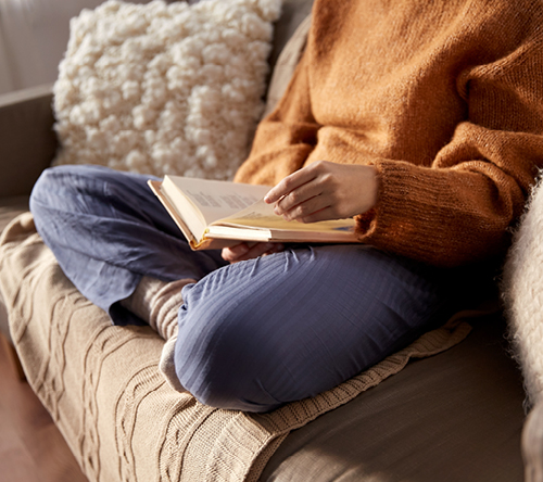 Cozying up with a book and glass of wine in hand